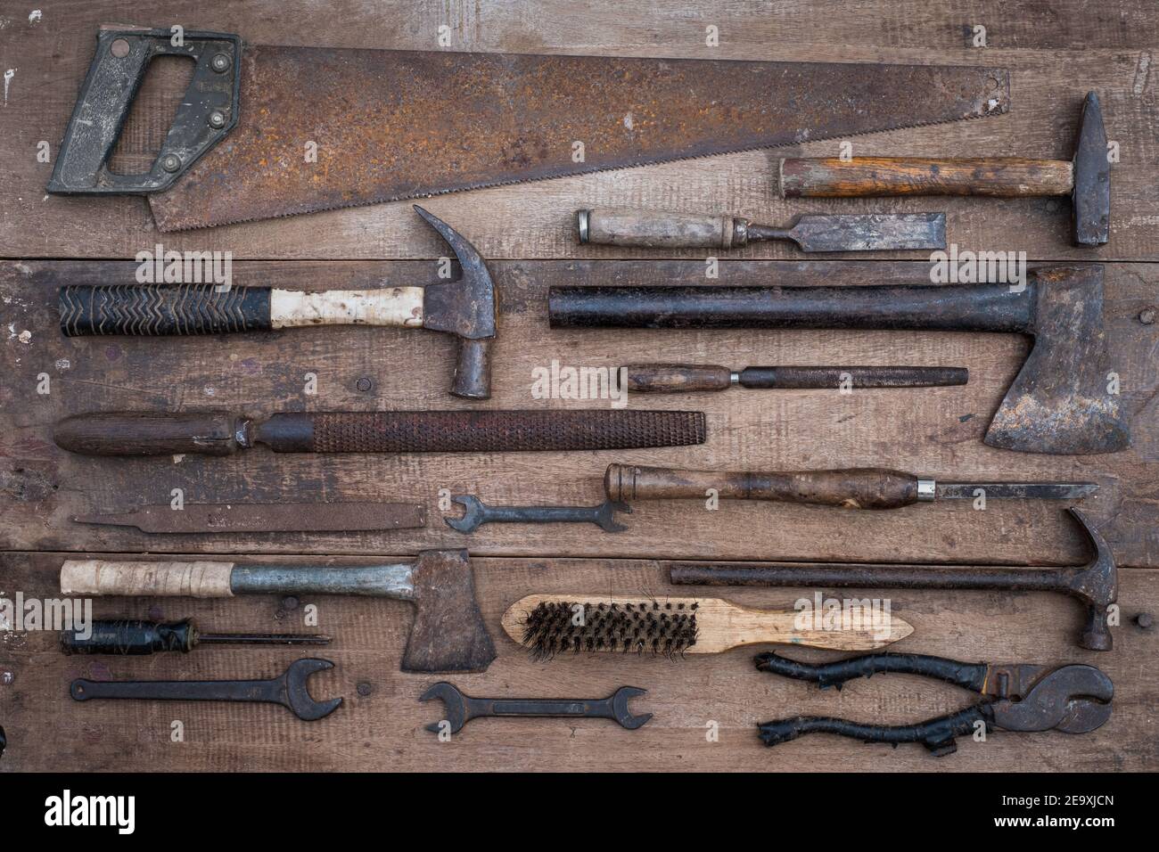 Collection of antique woodworking handtools on a rough workbench old wooden Stock Photo