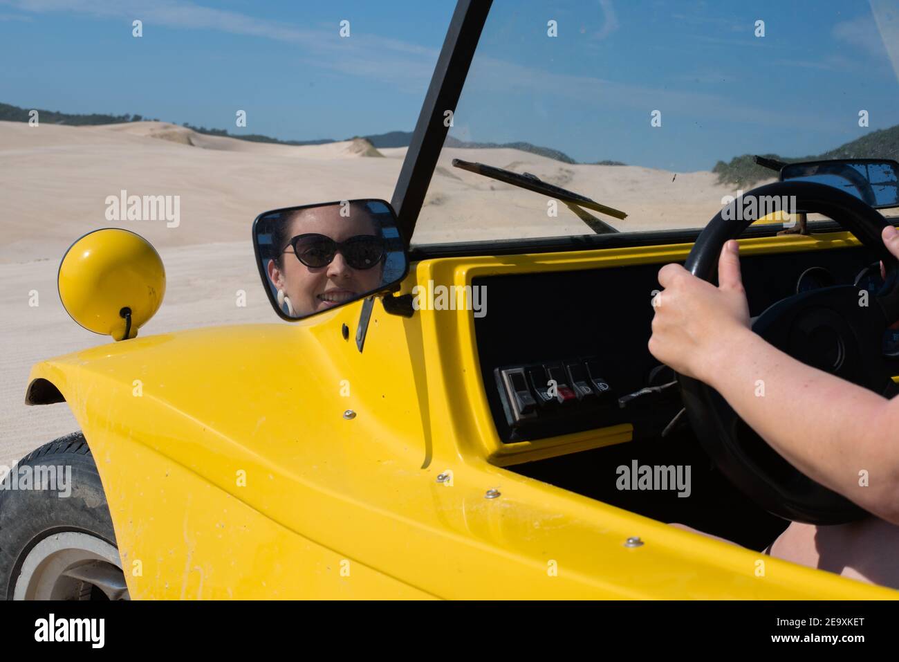 Woman driving on sand dunes Stock Photo Alamy