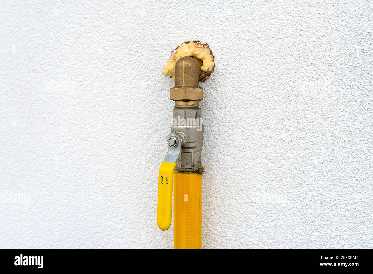 Gas valve located on the facade of the building, supplying gas to the boiler room, with a yellow