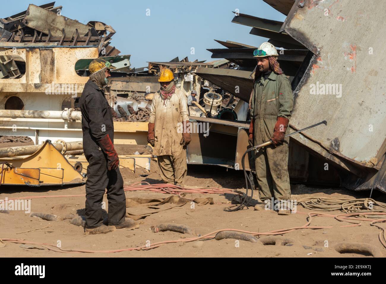 Workers breaking up ships, Gadani ship-breaking yard, located across a 10 km long beachfront, Balochistan, Pakistan. Stock Photo