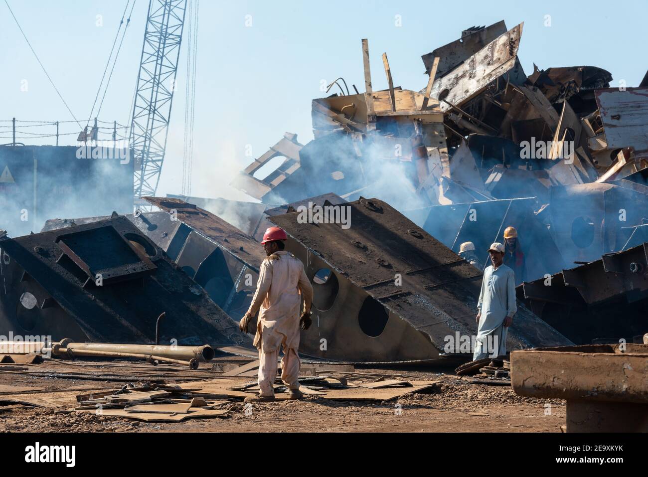 Workers breaking up ships, Gadani ship-breaking yard, located across a 10 km long beachfront, Balochistan, Pakistan. Stock Photo