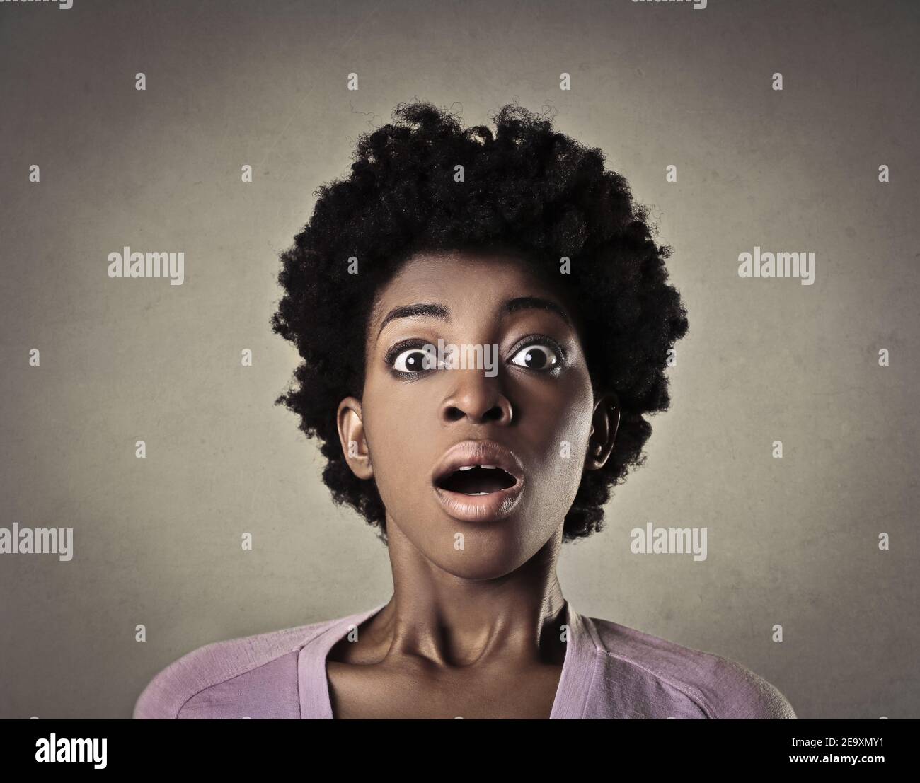 Portrait Of A Scared And Shocked African Woman With Short Curly Hair Against A Brown Background Stock Photo Alamy
