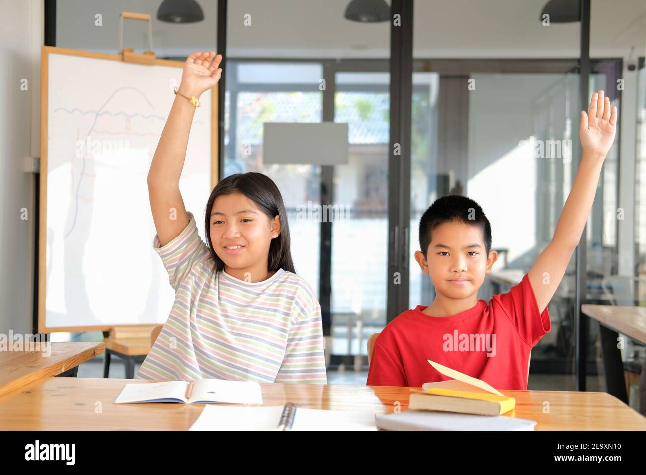 asian girl boy student studying raising hand in classroom. learning ...