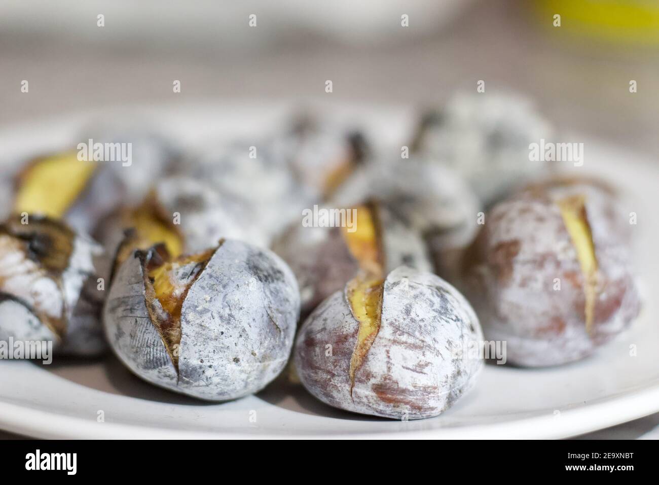 Roasted chestnuts on white plate Stock Photo