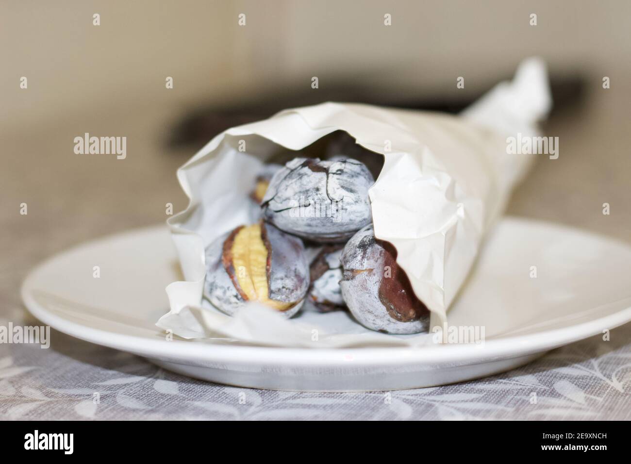 Roasted chestnuts on white plate Stock Photo