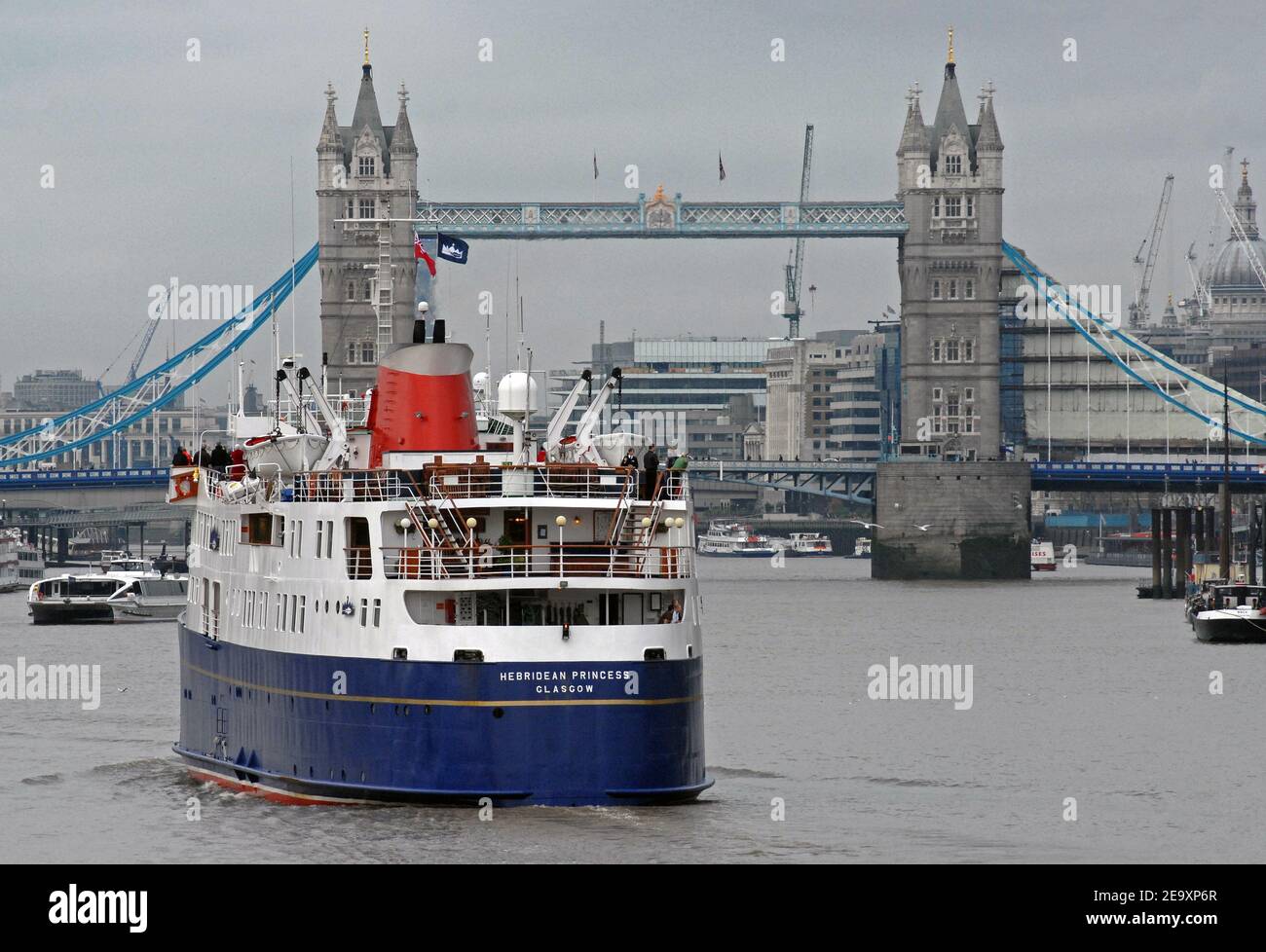 HEBRIDEAN PRINCESS cruising the RIVER THAMES passing BERMONDSEY WALL with TOWER BRIDGE, LONDON, ENGLAND Stock Photo