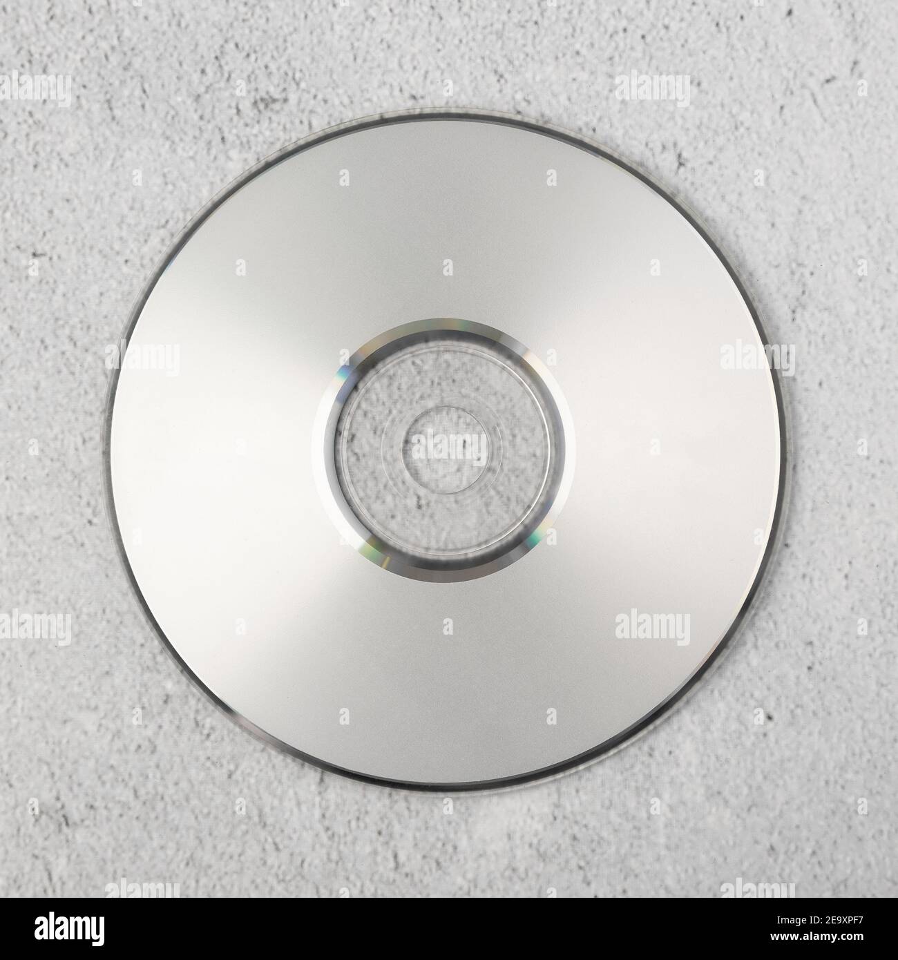 Realistic white cd template on white cement background. Stock Photo