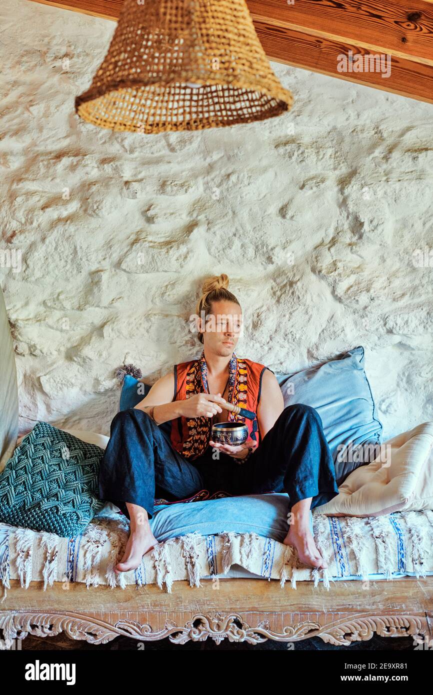 Blond man practicing meditation at home Stock Photo