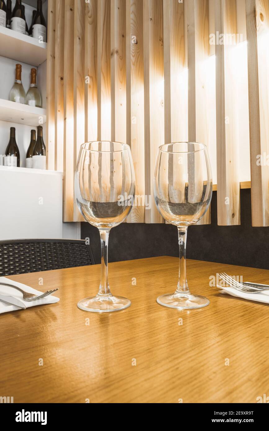 Fragile empty goblets standing on wooden table Stock Photo