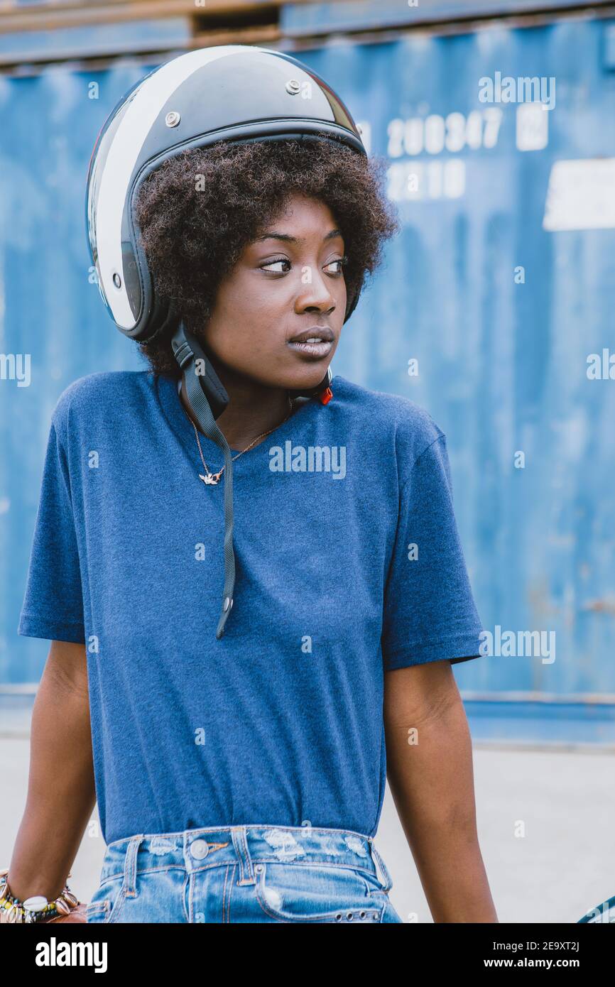Concentrated young black female biker with Afro hair in trendy outfit and helmet while sitting on motorcycle at seaside Stock Photo - Alamy Concentrated young black female biker with Afro hair in trendy outfit and helmet while sitting on motorcycle at seaside Stock Photo - Alamy