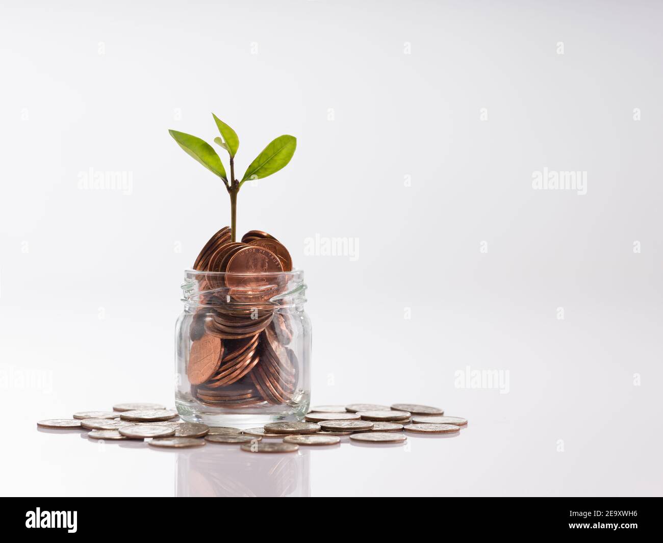 Coins on glass bottle - investment ideas for growth Stock Photo