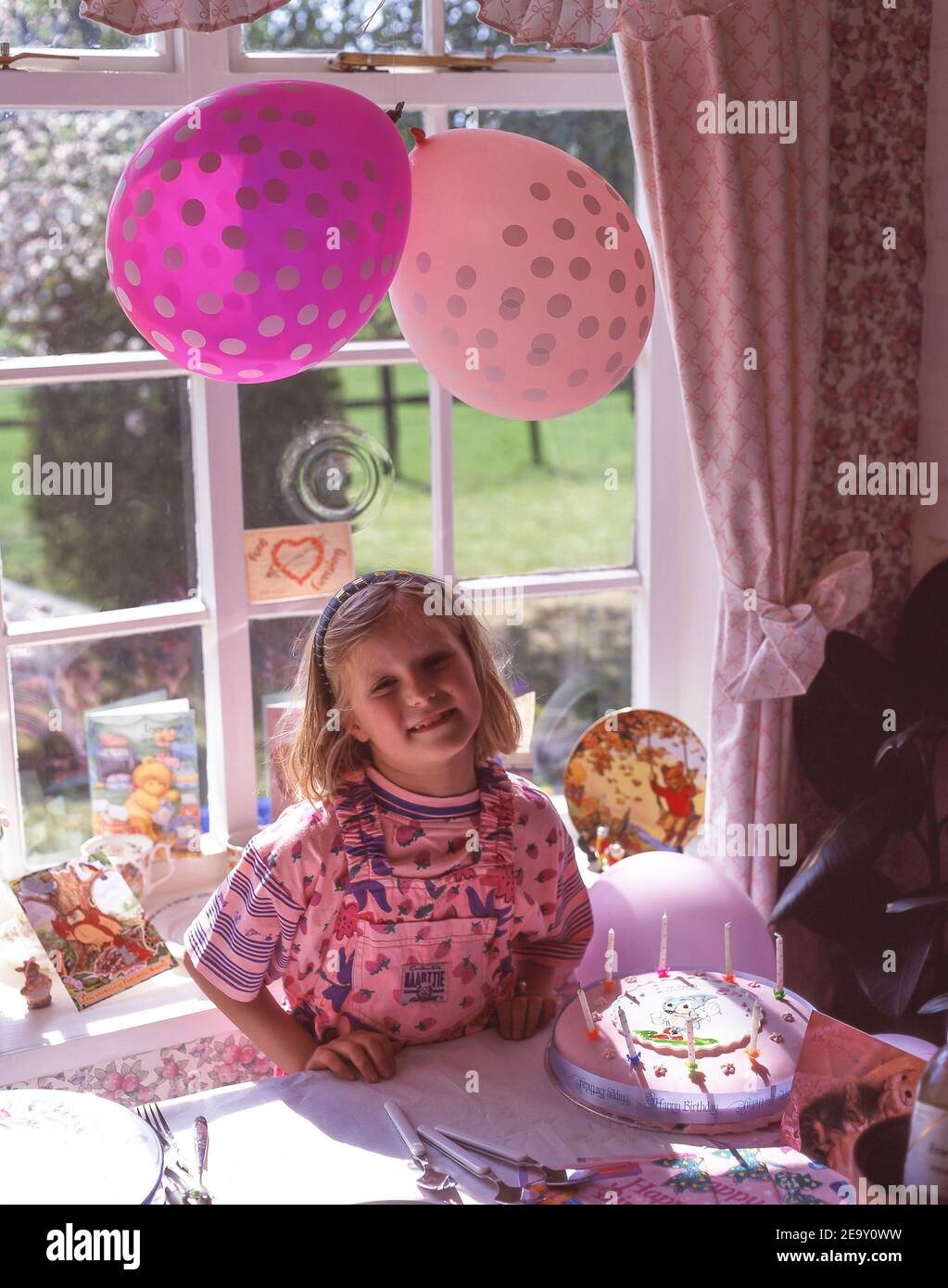 Young girl with her 8th birthday cake, Winkfield, Berkshire, England, United Kingdom Stock Photo