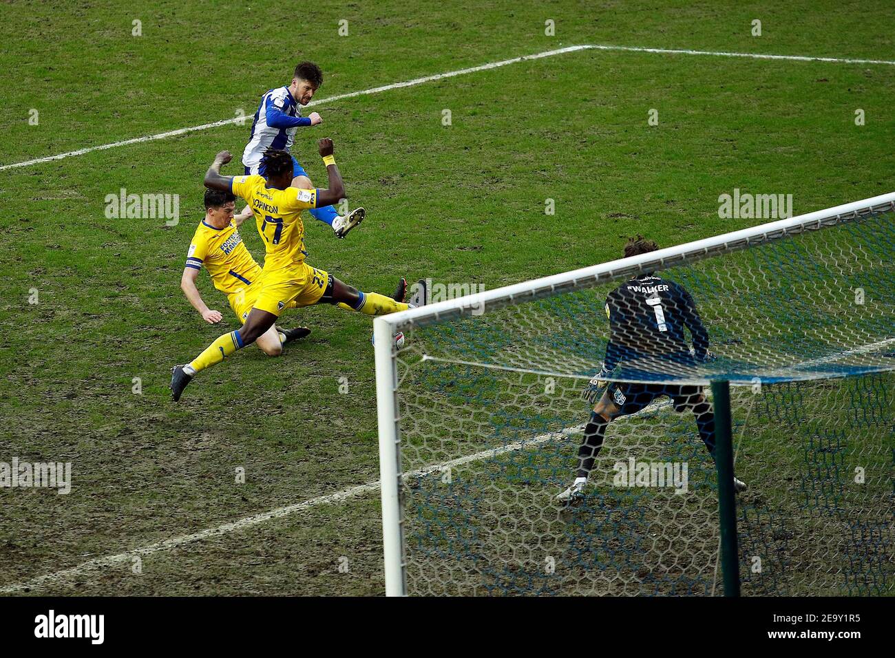 WIGAN, ENGLAND. FEB 6TH: Wigans Jamie Proctor shoots and scores to make it 2-2 during the Sky Bet League 1 match between Wigan Athletic and AFC Wimbledon at the DW Stadium, Wigan on Saturday 6th February 2021. (Credit: Chris Donnelly | MI News) Credit: MI News & Sport /Alamy Live News Stock Photo