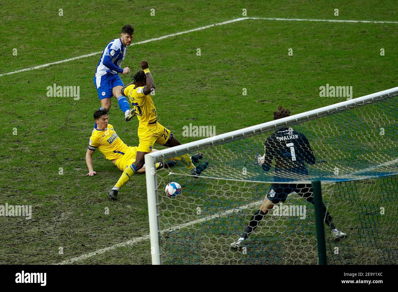 WIGAN, ENGLAND. FEB 6TH: Wigans Jamie Proctor shoots and scores to make it 2-2 during the Sky Bet League 1 match between Wigan Athletic and AFC Wimbledon at the DW Stadium, Wigan on Saturday 6th February 2021. (Credit: Chris Donnelly | MI News) Credit: MI News & Sport /Alamy Live News Stock Photo
