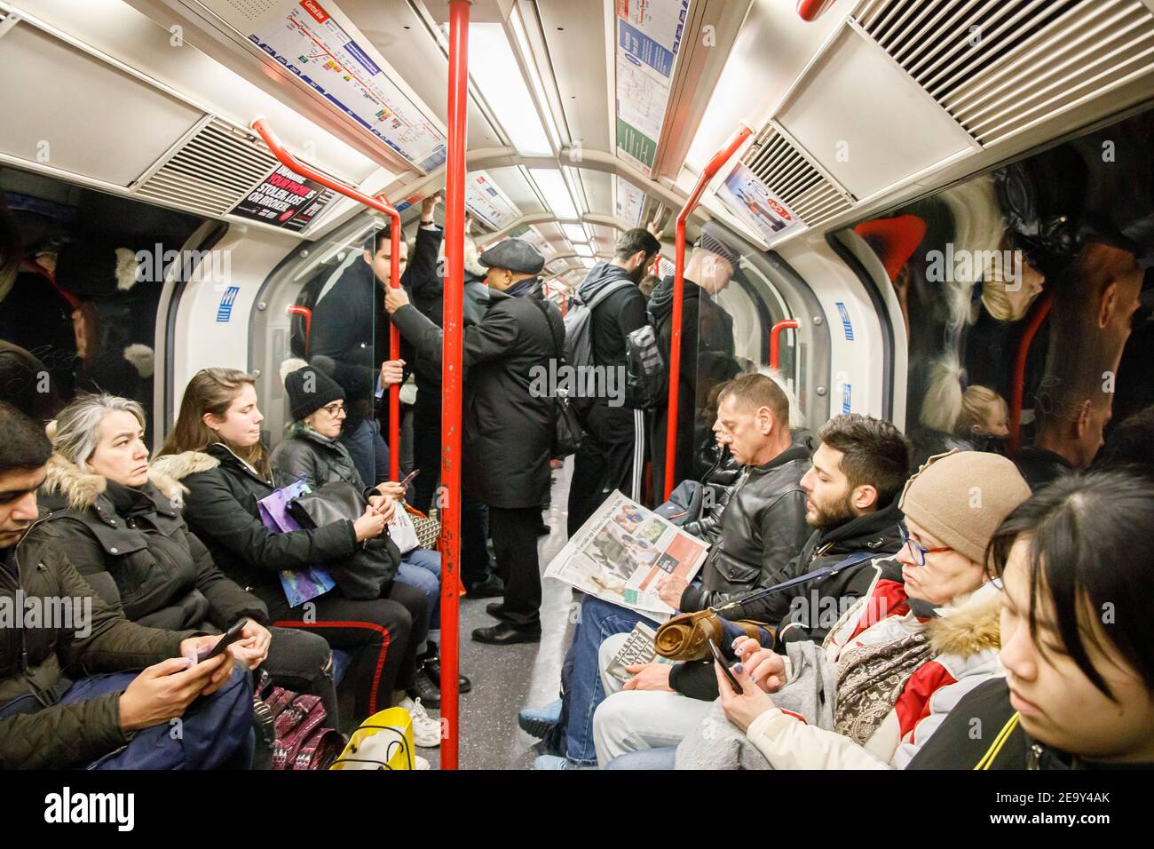 London underground tube train carriage crowded with people Stock Photo