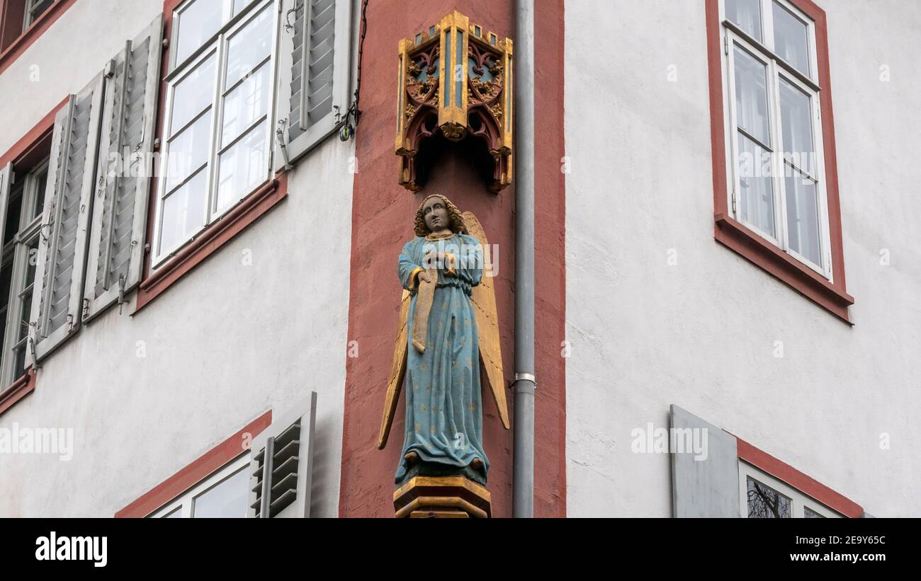 Guardian angel on the facade of an urban house from a frog's eye perspective Stock Photo