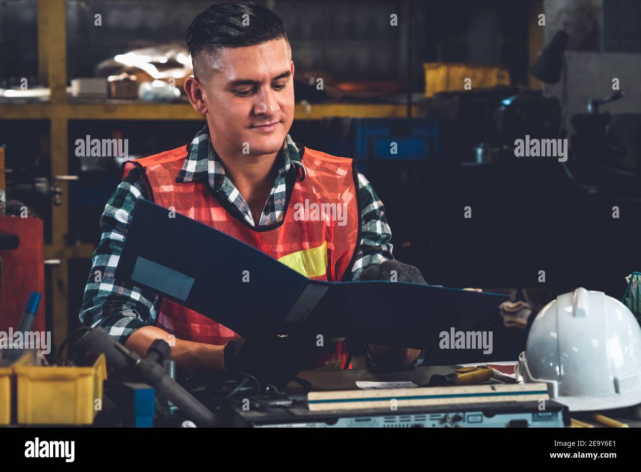 Manufacturing worker working with clipboard to do job procedure