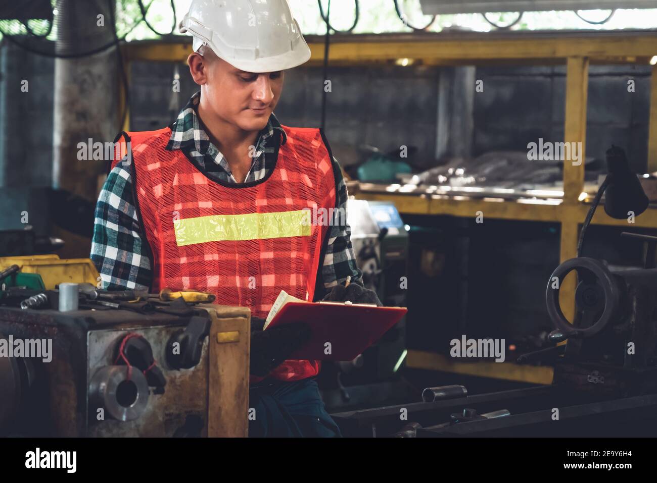 Manufacturing worker working with clipboard to do job procedure