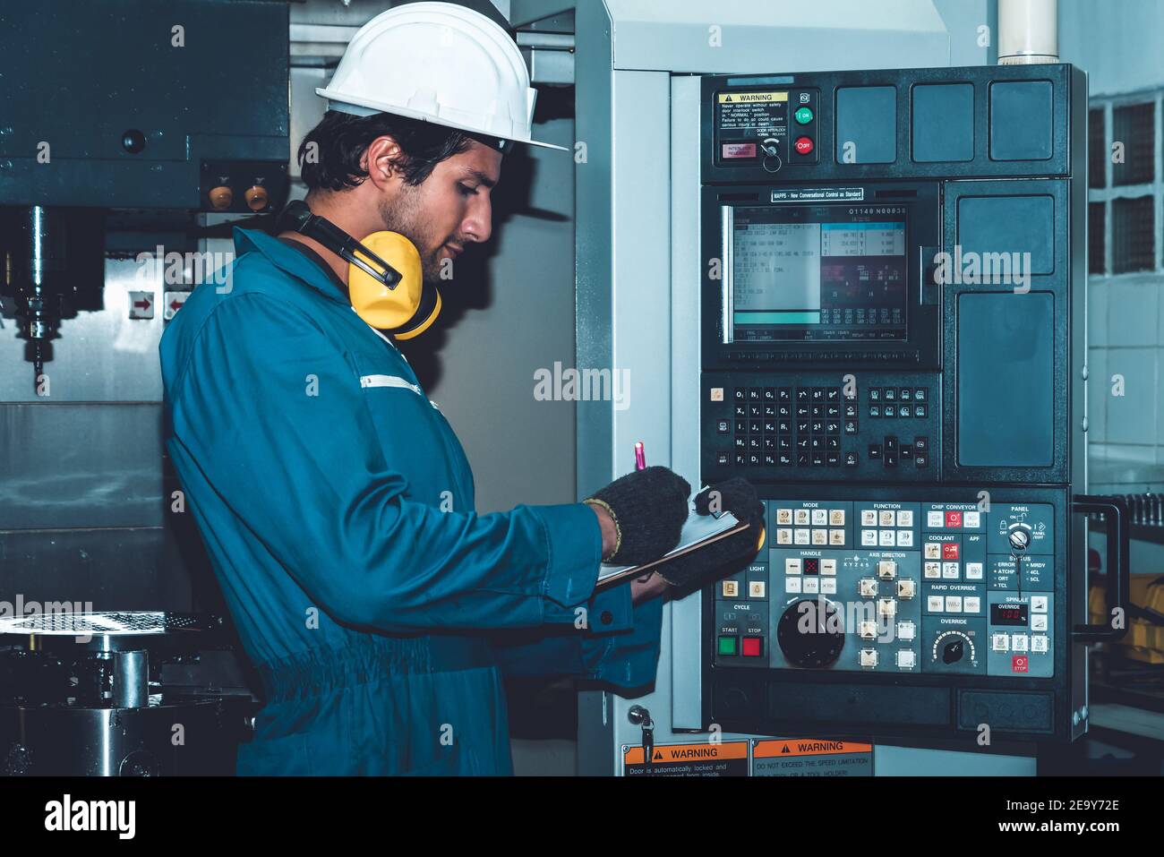 Smart factory worker or engineer do machine job in manufacturing workshop . Industry and engineering concept . Stock Photo