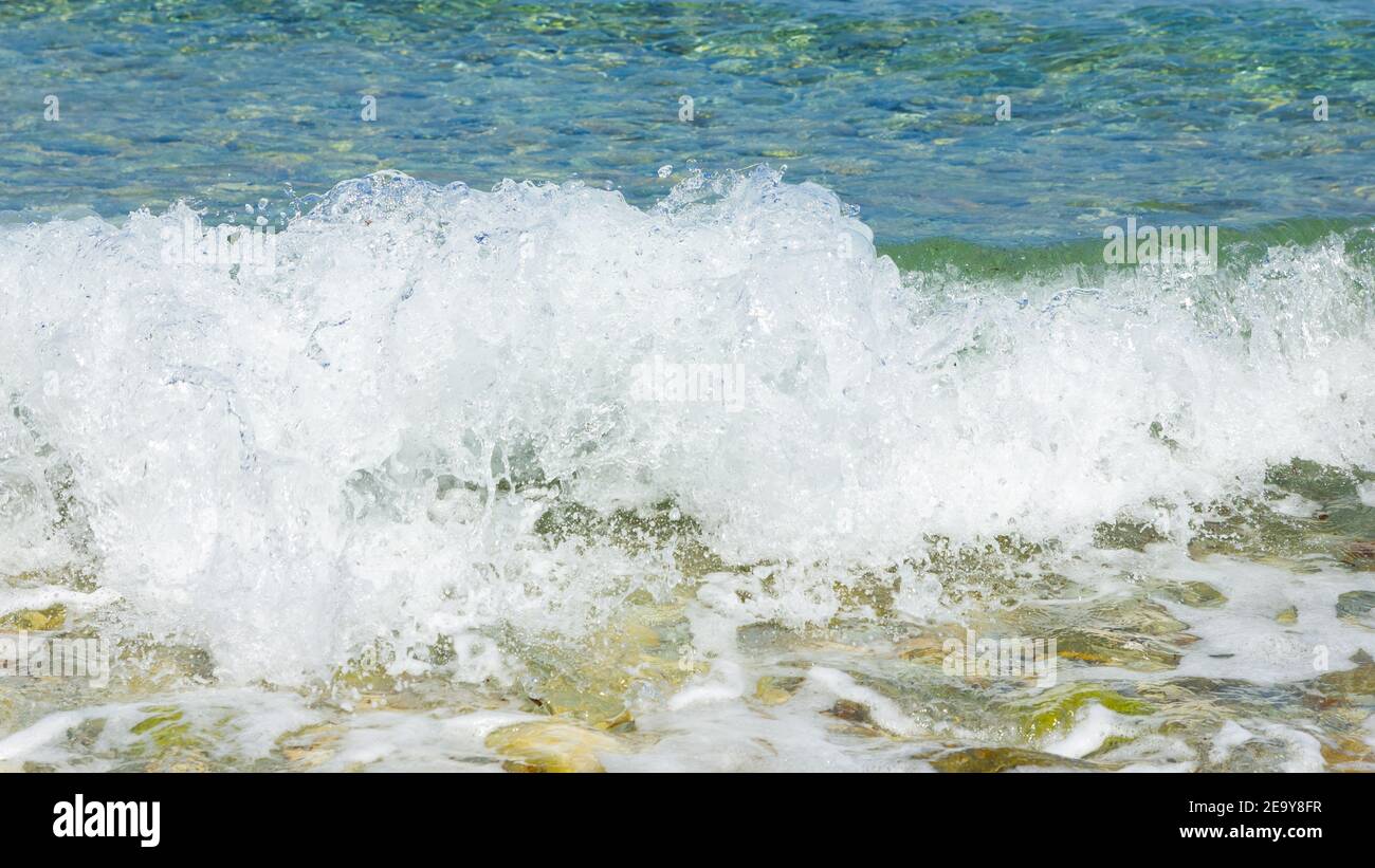 Pibble Wave Sea wave and pebble. Summer vacation concept. Sea wave with foam ...