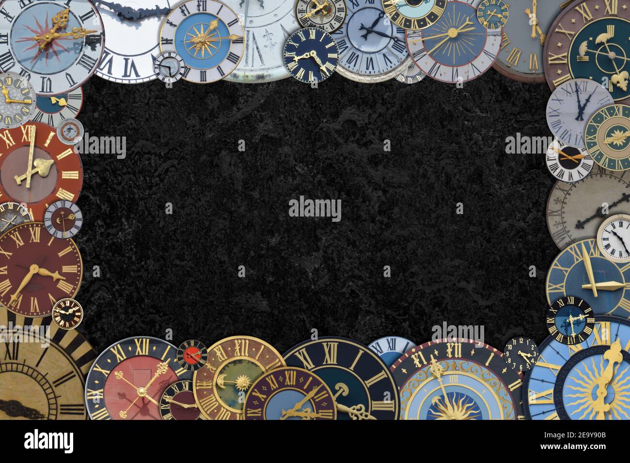 frame out of a collection of multicolored ancient church tower clocks in different sizes and forms with roman numbers around black copy space middle Stock Photo