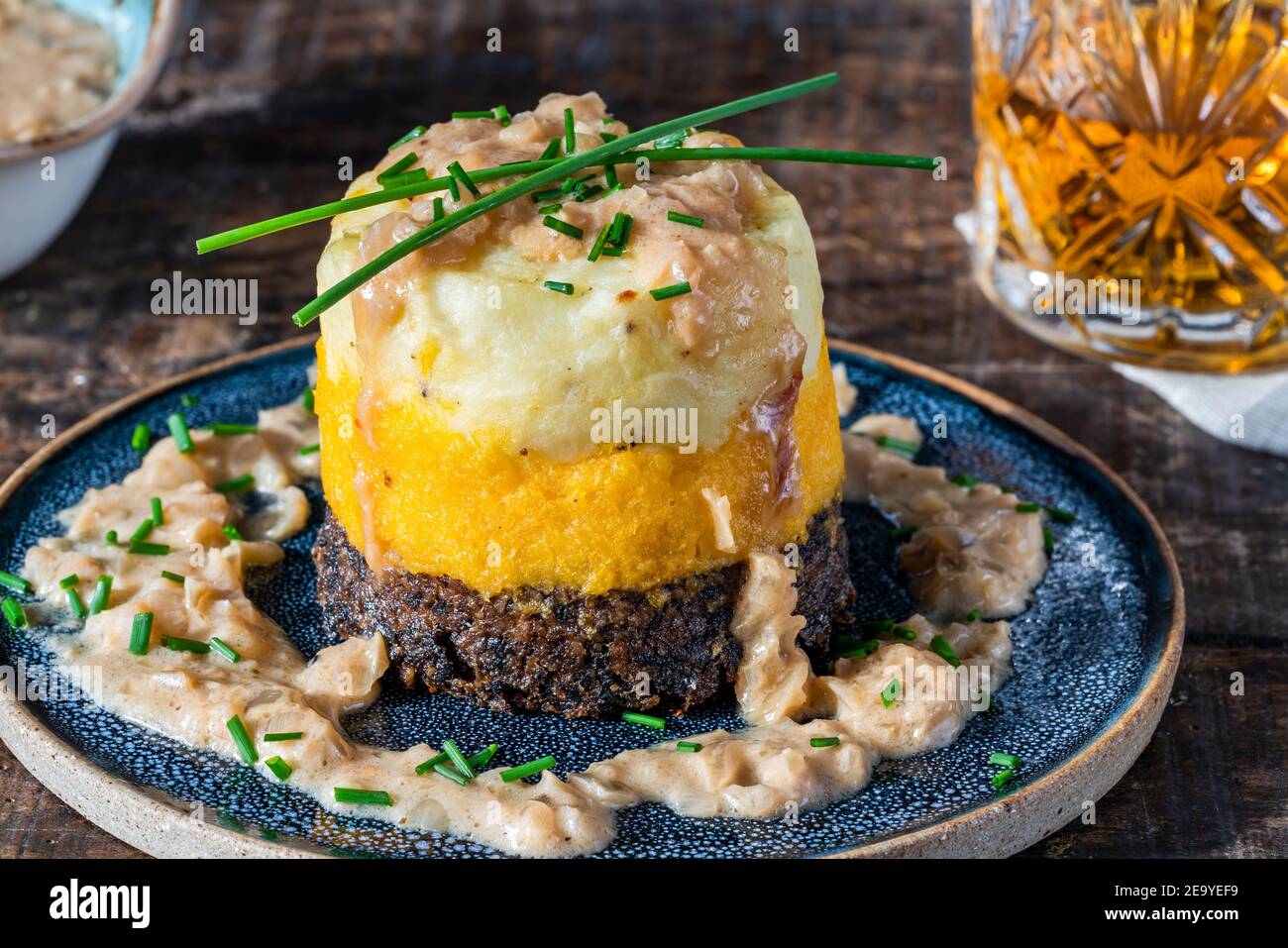Haggis, neeps and tatties stack (haggis with turnips and potatoes) with whisky  sauce - traditional Scottish dish for Burns Night Stock Photo - Alamy