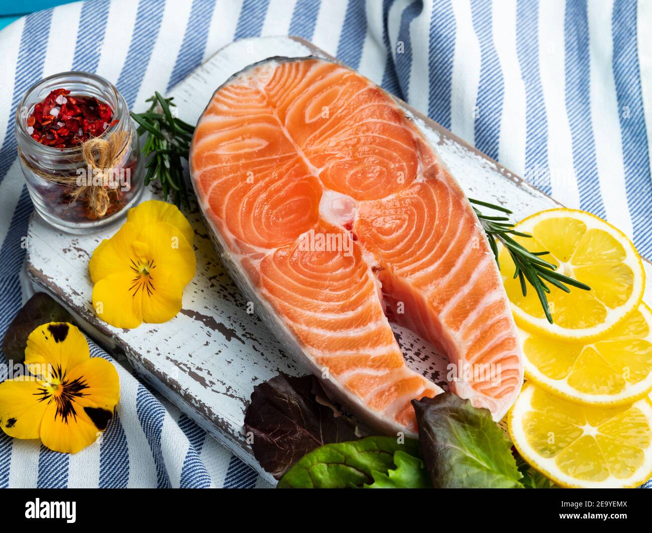 raw fresh steak fish trout, salmon and spices on blue wooden background, closeup Stock Photo
