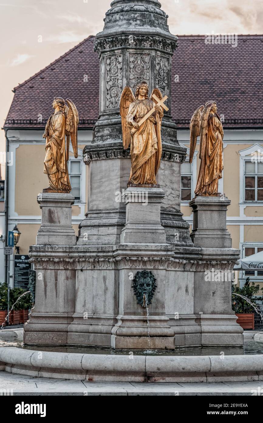 Zagreb, Croatia - Aug 10, 2020: Golden angel holding cross on fountain in front of Zagreb Cathedral Stock Photo