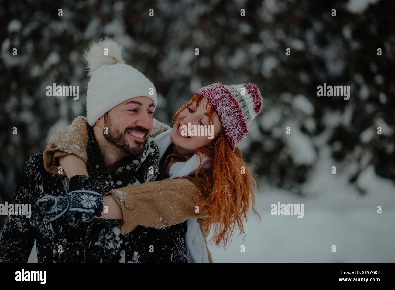 Beautiful view of a girl hugging her boyfriend from the back and having ...