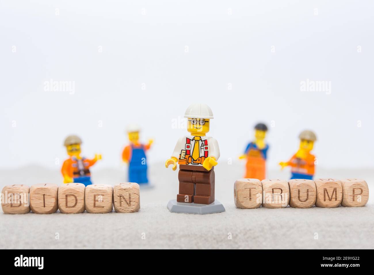 Wooden cubes with letters denoting the names of the presidents, and a toys in the form of toys of different workers. Conceptual photography. Children' Stock Photo