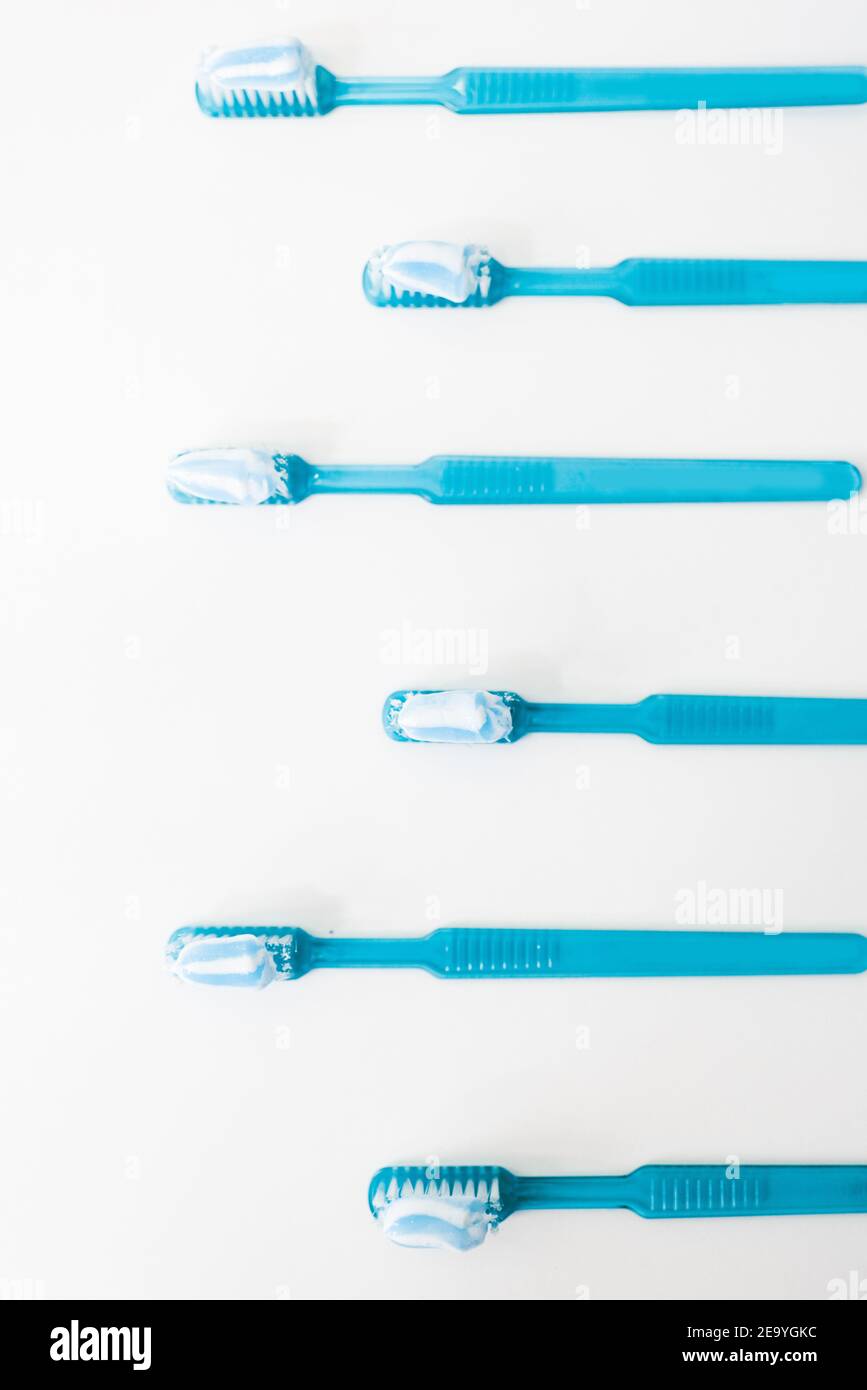 Plastic blue toothbrushes with toothpaste isolated on a white background Stock Photo