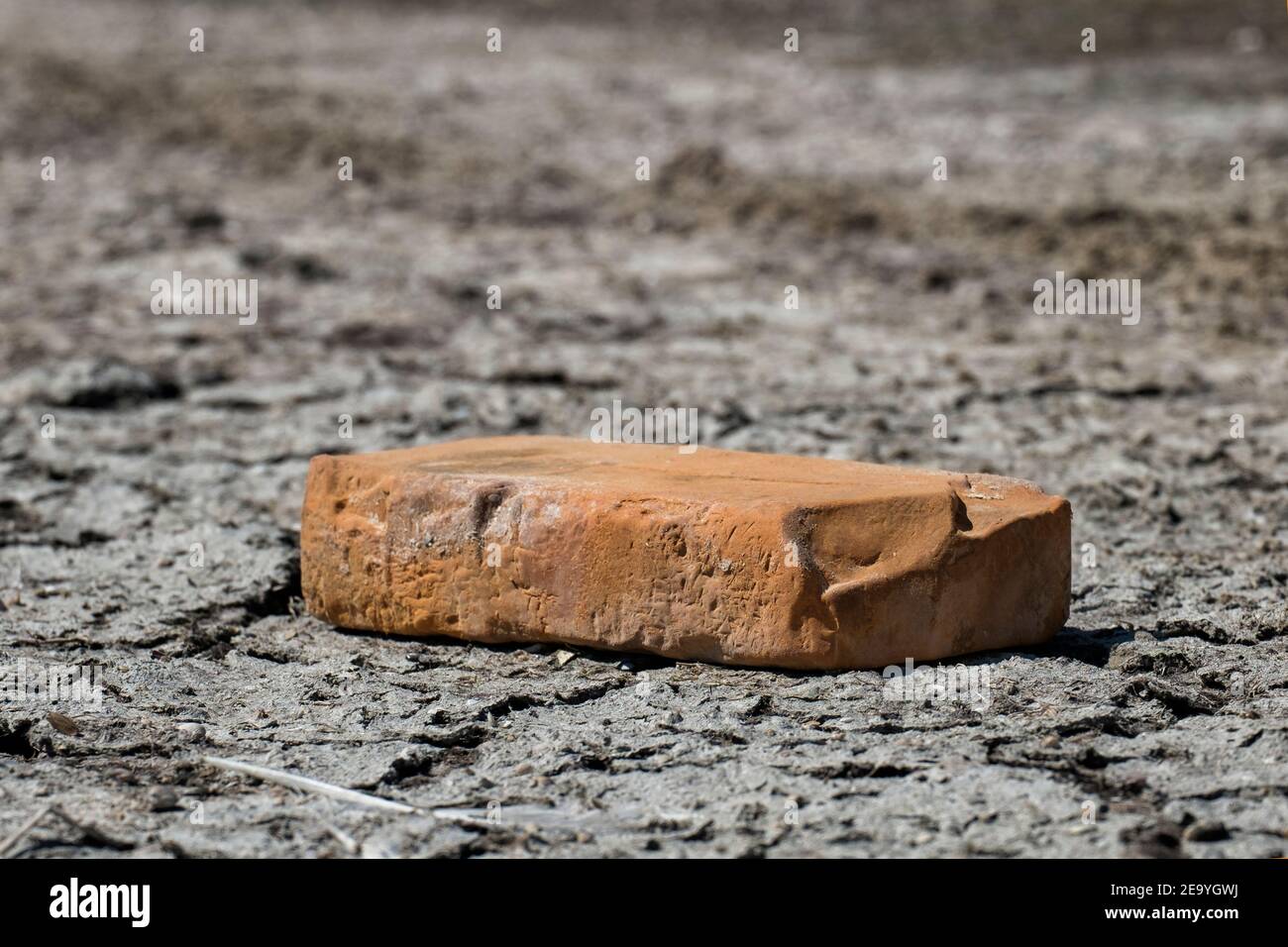 Vintage red brick lies on gray ground Stock Photo