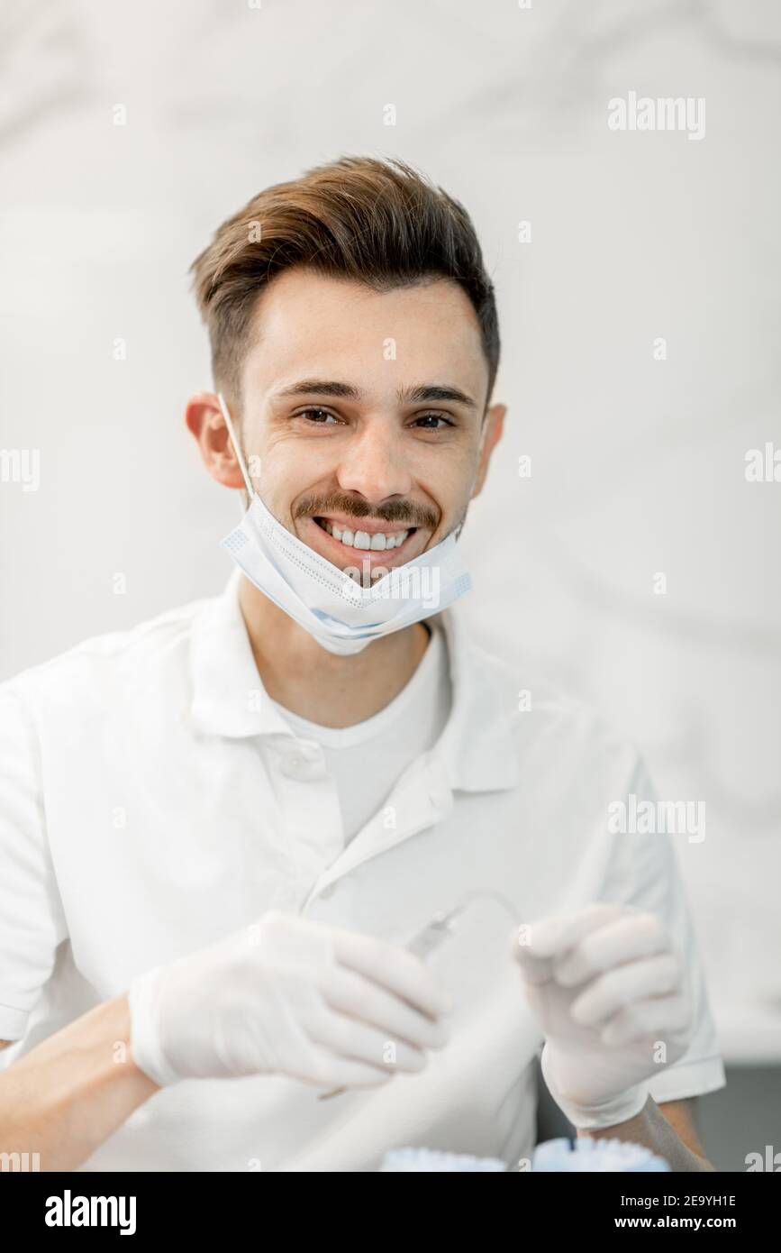 Dental technician working with a model of teeth and dental braces Stock