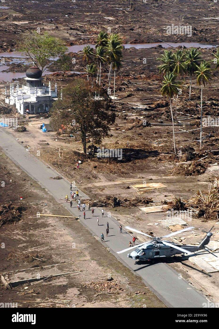 An SH-60B Seahawk helicopter, assigned to the 'Saberhawks' of Helicopter Anti-Submarine Squadron Light Four Seven (HSL-47), lands to distribute relief supplies at a village in the island of Sumatra, Indonesia. Helicopters assigned to Carrier Air Wing Two (CVW-2) and Sailors from USS Abraham Lincoln (CVN 72) are supporting Operation Unified Assistance, the humanitarian operation effort in the wake of the Tsunami that struck South East Asia. Photo by Jacob J. Kirk/USN via ABACA. Stock Photo