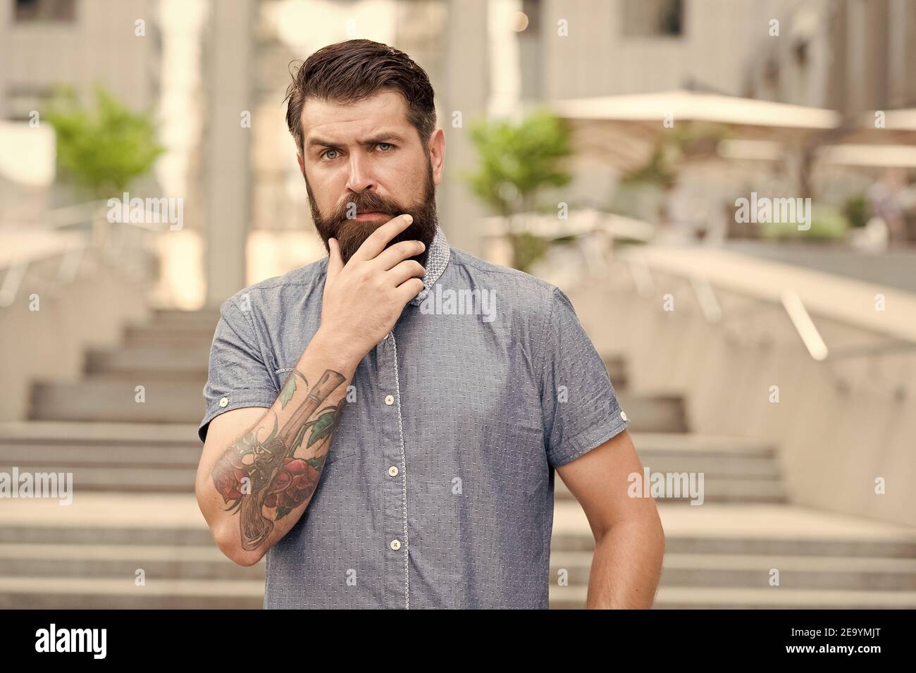My beard my look. Bearded man touch beard urban outdoor. Hipster wear unshaven beard and mustache. Beard growth products. Barbershop. Hair salon. Mens grooming. Keep your facial hair and skin soft Stock My beard my look. Bearded man touch beard urban outdoor. Hipster wear unshaven beard and mustache. Beard growth products. Barbershop. Hair salon. Mens grooming. Keep your facial hair and skin soft Stock