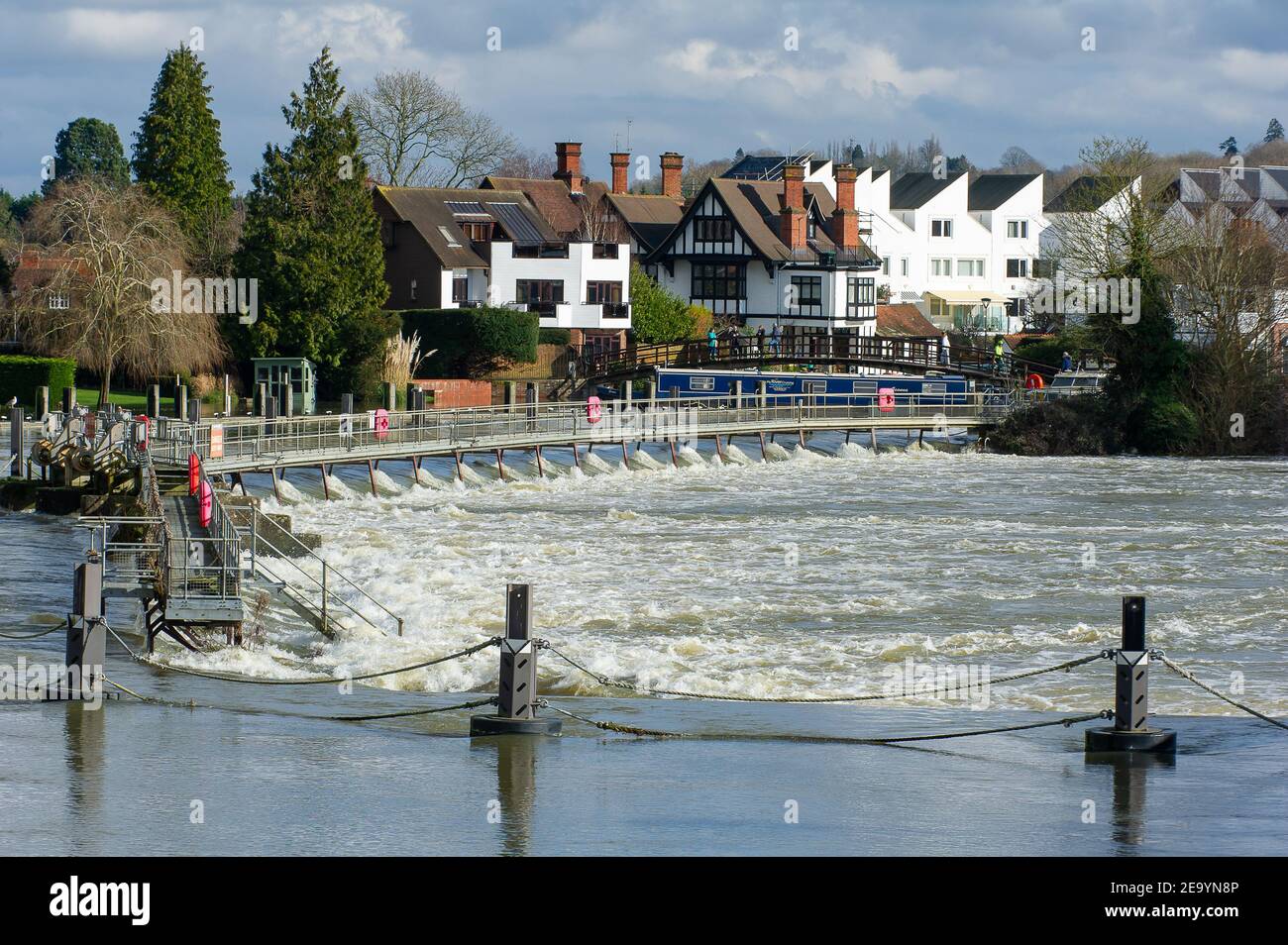 Marlow, Buckinghamshire, UK. 6th February, 2021. A strong current in the water at Marlow Lock. A Flood Warning is in place for the River Thames at Marlow following a period of sustained recent rainfall. Residents living near to the River Thames are advised to activate their flood protection products. Property flooding is expected. River levels remain high and the Thames Path is flooded. The Environment Agency are expecting river levels to rise again this weekend due to the forecast rain and possible snow. Credit: Maureen McLean/Alamy Stock Photo