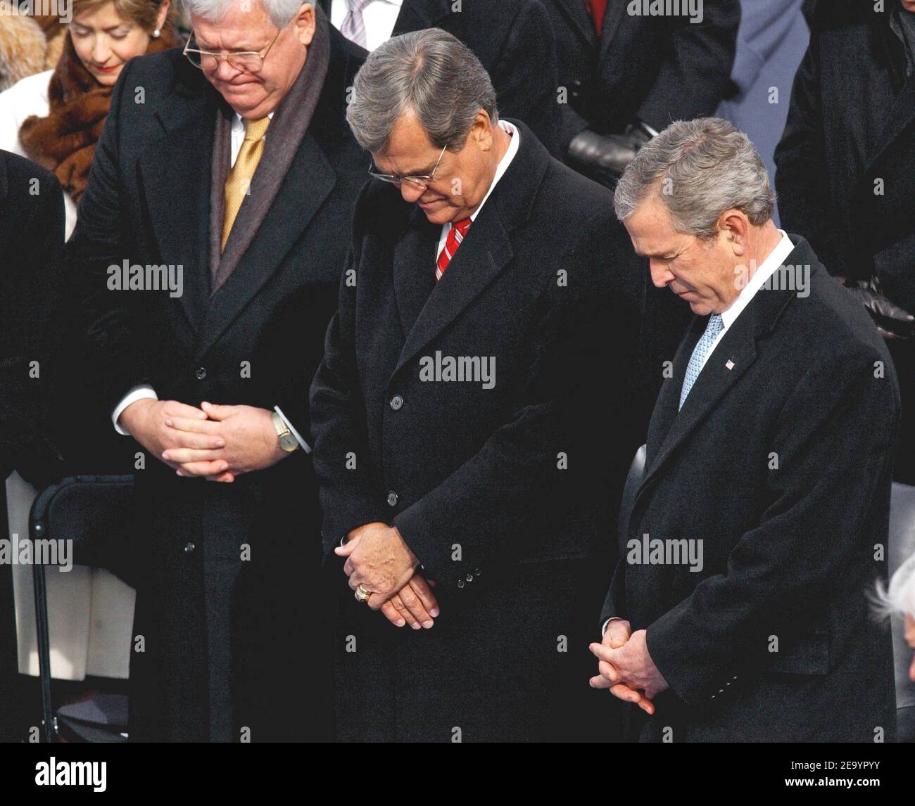 From left, Speaker of the House Dennis Hastert, former Senator Trent Lott and President George W. Bush bow their heads as the invocation is made, during Inauguration ceremonies on the west front of the U.S. Capitol January 20, 2005, in Washington, D.C. Photo by Douliery-Khayat/ABACA. Stock Photo