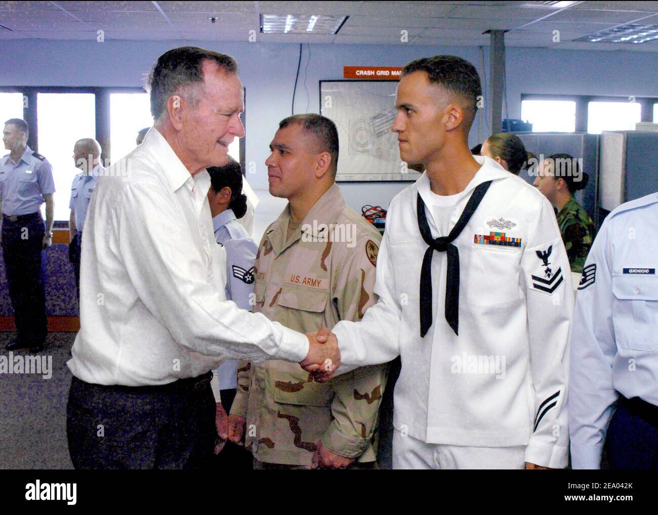 Former President George H. W. Bush shakes the hand of Builder 2nd Class Donald Wintersteen, assigned to Naval Mobile Construction Battalion Seven (NMCB-7), who helped in reconstruction efforts in Sri Lanka after the tsunami ravaged the region. Presidents Bush and Clinton are touring Sri Lanka, Thailand and Indonesia to see first hand, the effects the tsunami had on Southeast Asia on February 19, 2005. Photo by Paul Williams/USN via ABACA. Stock Photo
