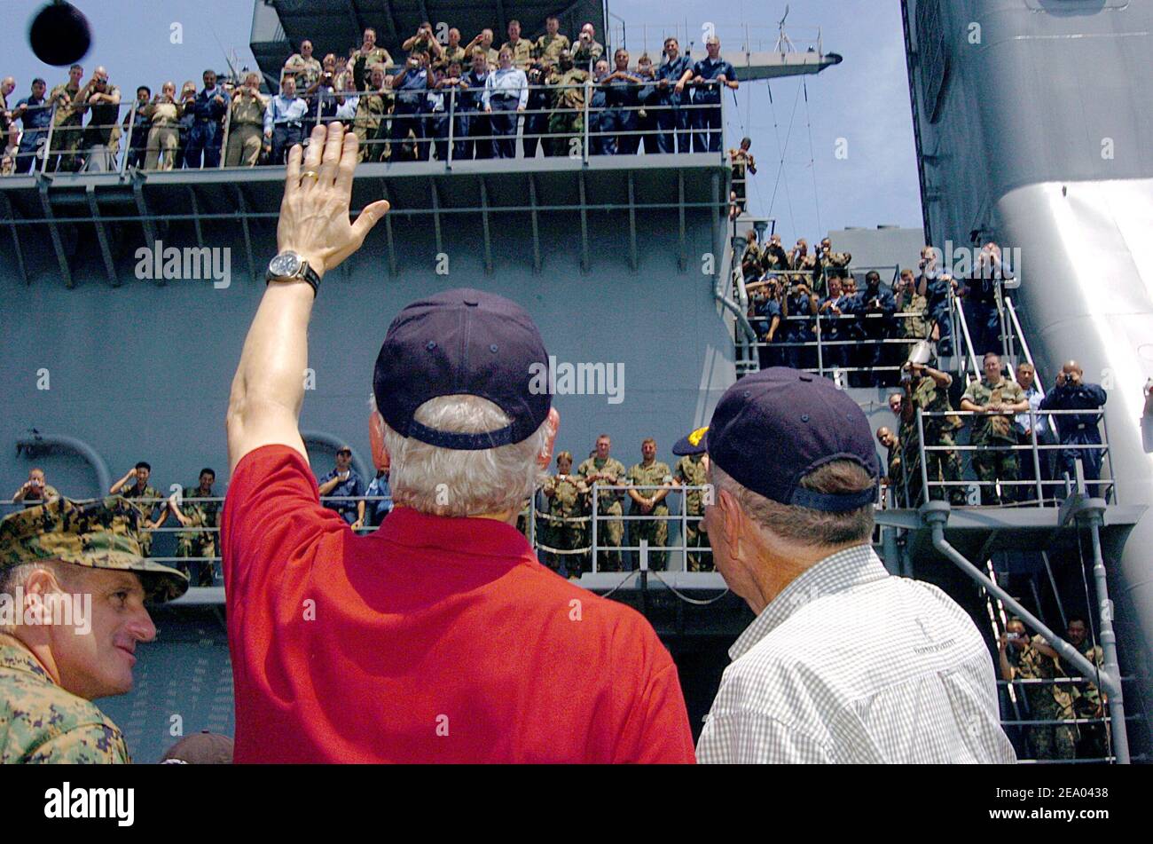 Former Presidents Bill Clinton, left, and George H. W. Bush wave to a large crowd of Sailors and Marines after arriving by helicopter aboard the amphibious dock landing ship USS Fort McHenry (LSD 43), while off the Indonesian coast. Sailors and Marines greeted the former Commander-in-Chiefs. Presidents Bush and Clinton are touring Sri Lanka, Thailand and Indonesia to see first hand, the effects the Tsunami had on Southeast Asia on February 20, 2005. Photo USN via ABACA. Stock Photo
