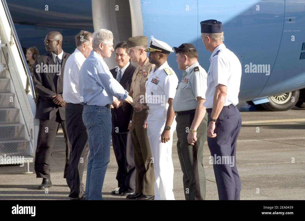 Former President Bill Clinton greets Commander, U.S. Naval Forces Marianas, Rear Adm. Arthur J. Johnson, during a fuel stop at Andersen Air Force Base on the U.S. territory of Yigo, Guam. Presidents Bush and Clinton are touring Sri Lanka, Thailand and Indonesia to see first hand, the effects the tsunami had on Southeast Asia on February 19, 2005. Photo by Nathanael T. Miller/USN via ABACA. Stock Photo