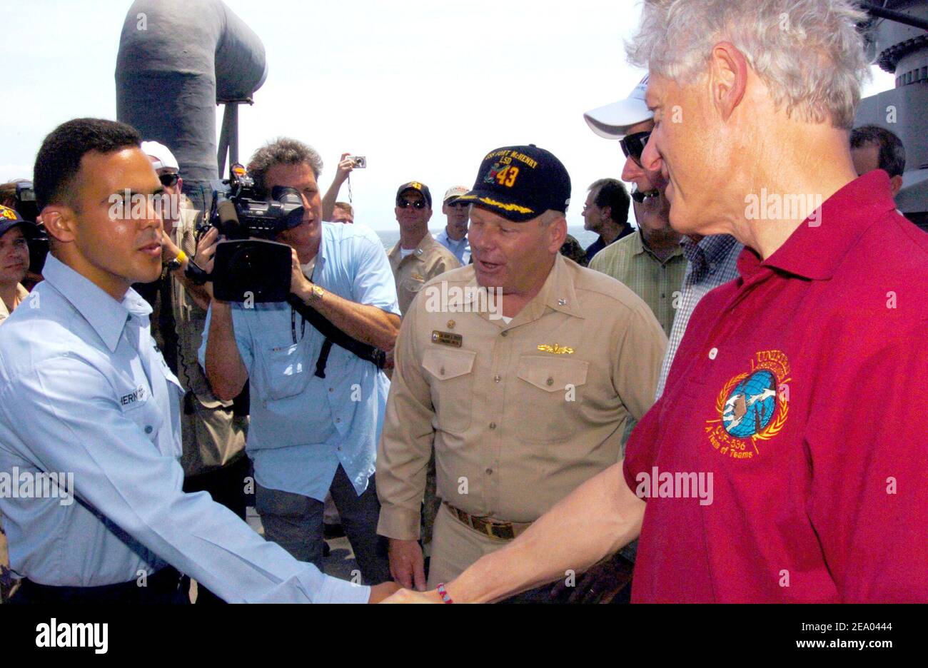 Former President Bill Clinton shakes the hand of Seaman Yandy Hernandez as he congratulates him aboard the amphibious dock landing ship USS Fort McHenry (LSD 43). Seaman Hernandez conducted more than 200 critical crane lifts for over 500,000 pounds of relief supplies during Operation Unified Assistance. Sailors and Marines greeted former President Clinton and George H. W. Bush as they toured Sri Lanka, Thailand and Indonesia to see first hand, the effects the tsunami had on Southeast Asia on February 20, 2005. Photo Michael D. Kennedy/USN via ABACA. Stock Photo