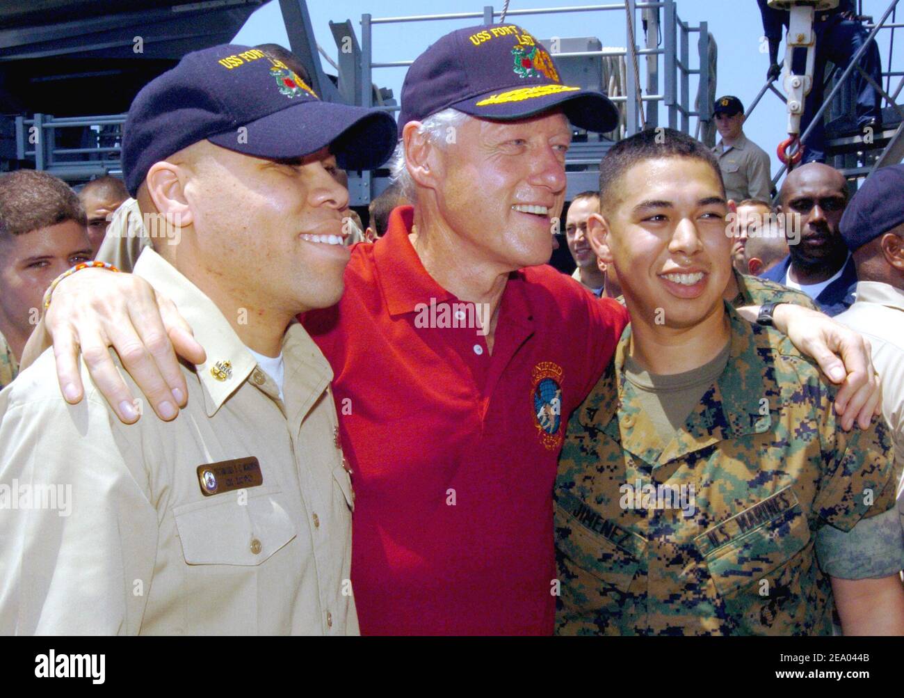 Former President Bill Clinton poses with Chief Operations Specialist David C. McAlister, left, and Lance Cpl. Angelo D. Jimenez aboard the amphibious dock landing ship USS Fort McHenry (LSD 43). Sailors and Marines greeted former President William J. Clinton and George H. W. Bush as they toured Sri Lanka, Thailand and Indonesia to see first hand, the effects the tsunami had on Southeast Asia on February 20, 2005. Photo Michael D. Kennedy/USN via ABACA. Stock Photo
