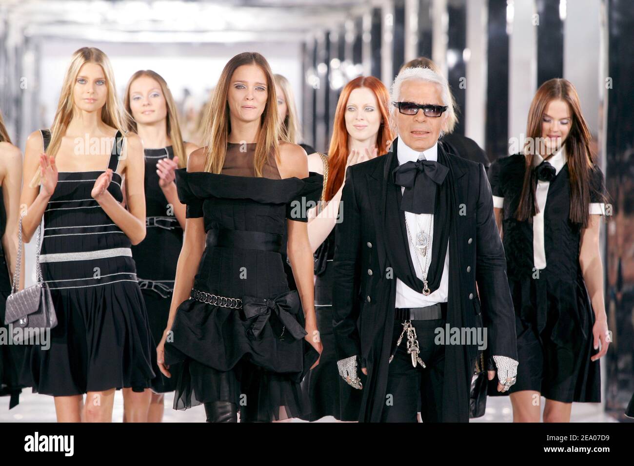 German fashion designer Karl Lagerfeld by models walks on the