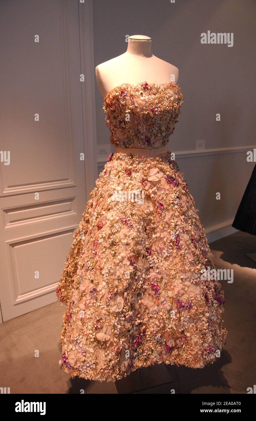 Bernard Arnault's daughter Delphine (C), Dior CEO Sidney Toledano (L) and  French fashion stylist Pierre Cardin pose beside items on display after a  press conference at the occasion of Christian Dior's centenary