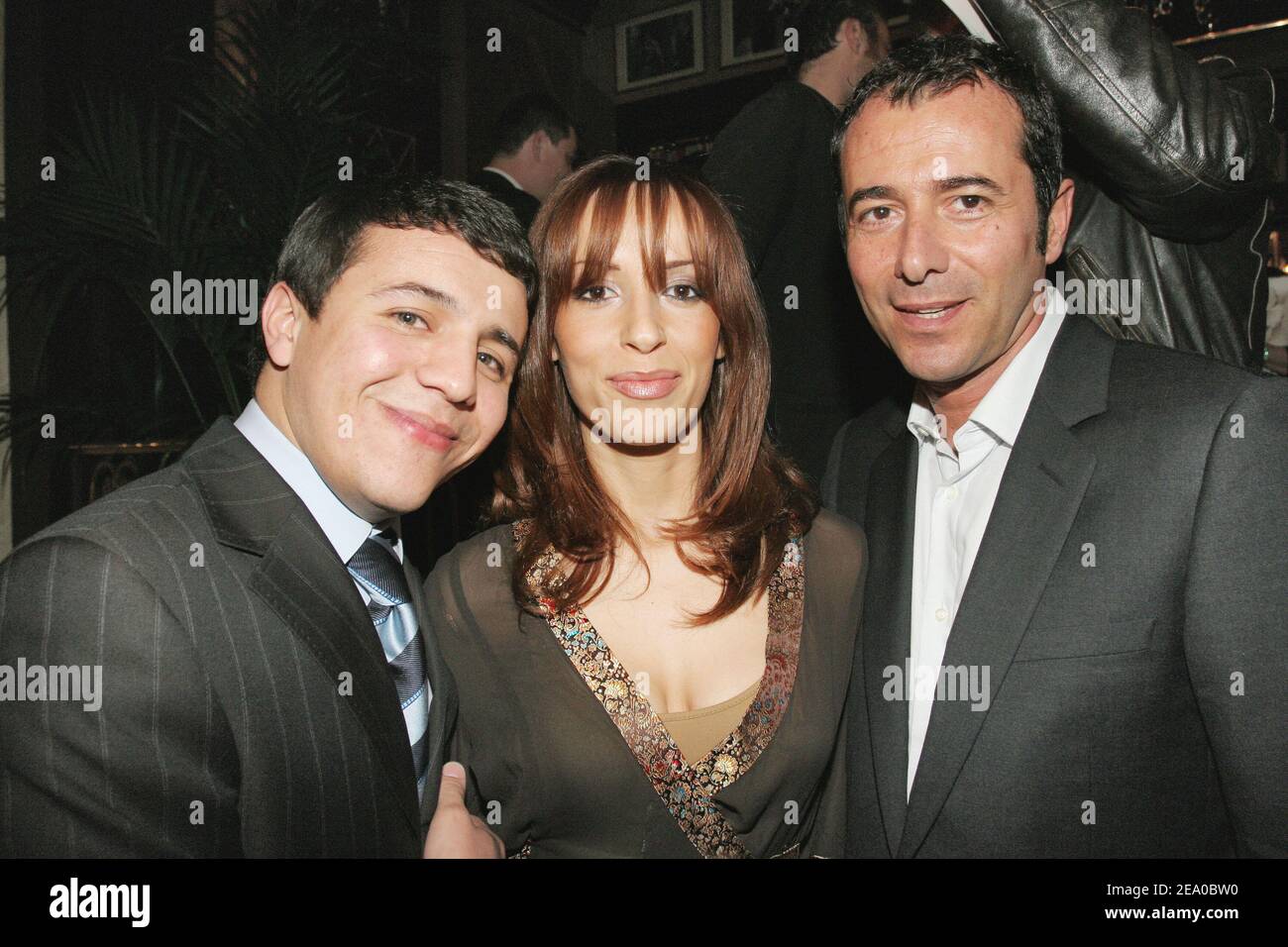 French rai singer Faudel (L), with his girlfriend Anissa, and French TV presenter Bernard Montiel pose at the giving ceremony of the '2005 Jean Gabin-Romy Schneider Prize' ceremony held at the Fouquet's in Paris, France, on March 21, 2005. Cecile de France received the 'Romy Schneider Prize' and Clovis Cornillac the 'Jean Gabin Prize'. Photo by Benoit Pinguet/ABACA. Stock Photo