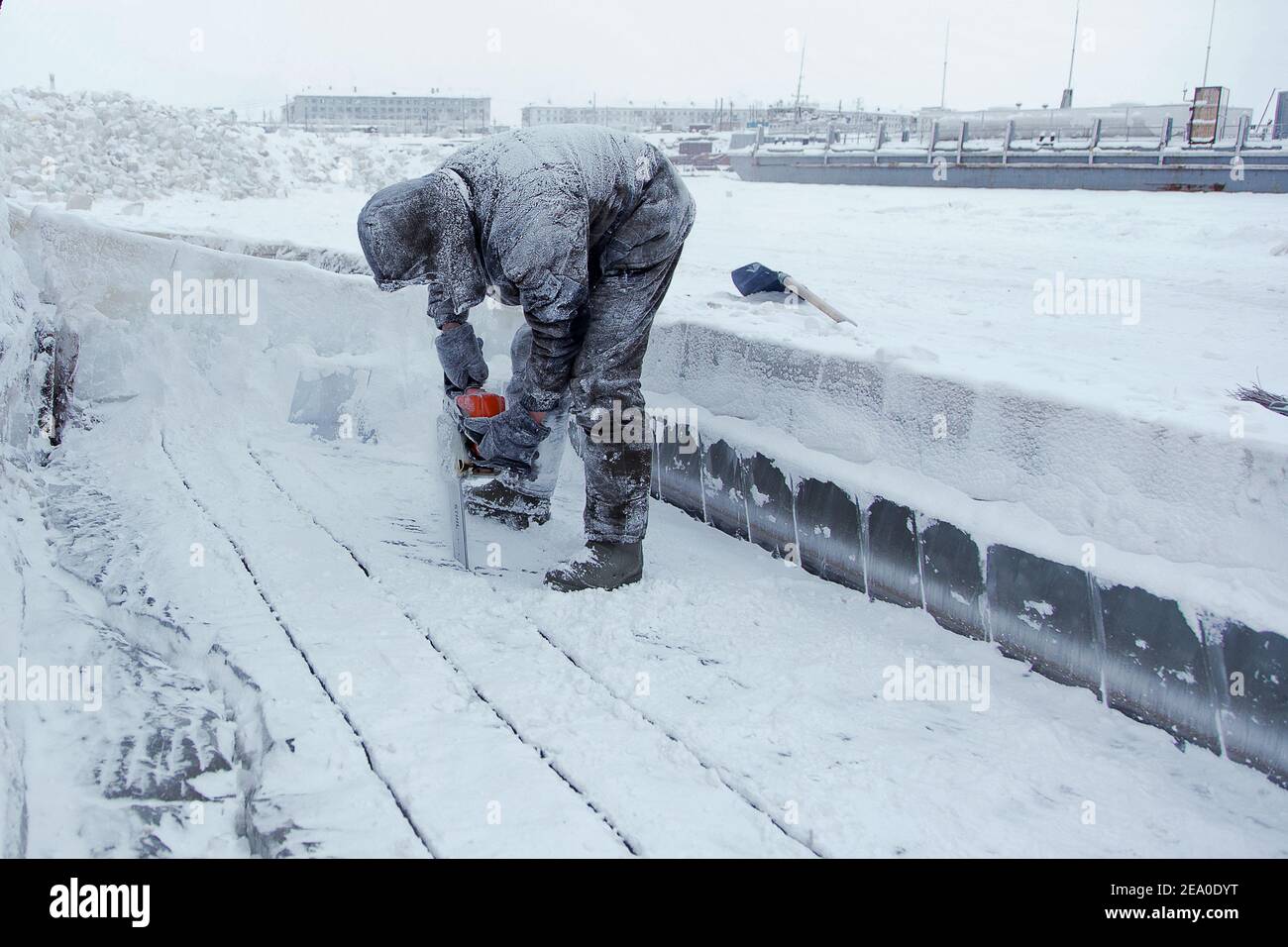 Yakutia Russia February 6 2021 A Worker Cuts The Ice With A Chainsaw On The Frozen Lena River At The Zhatai Shipyard In The Town Of Zhatai Just To The North