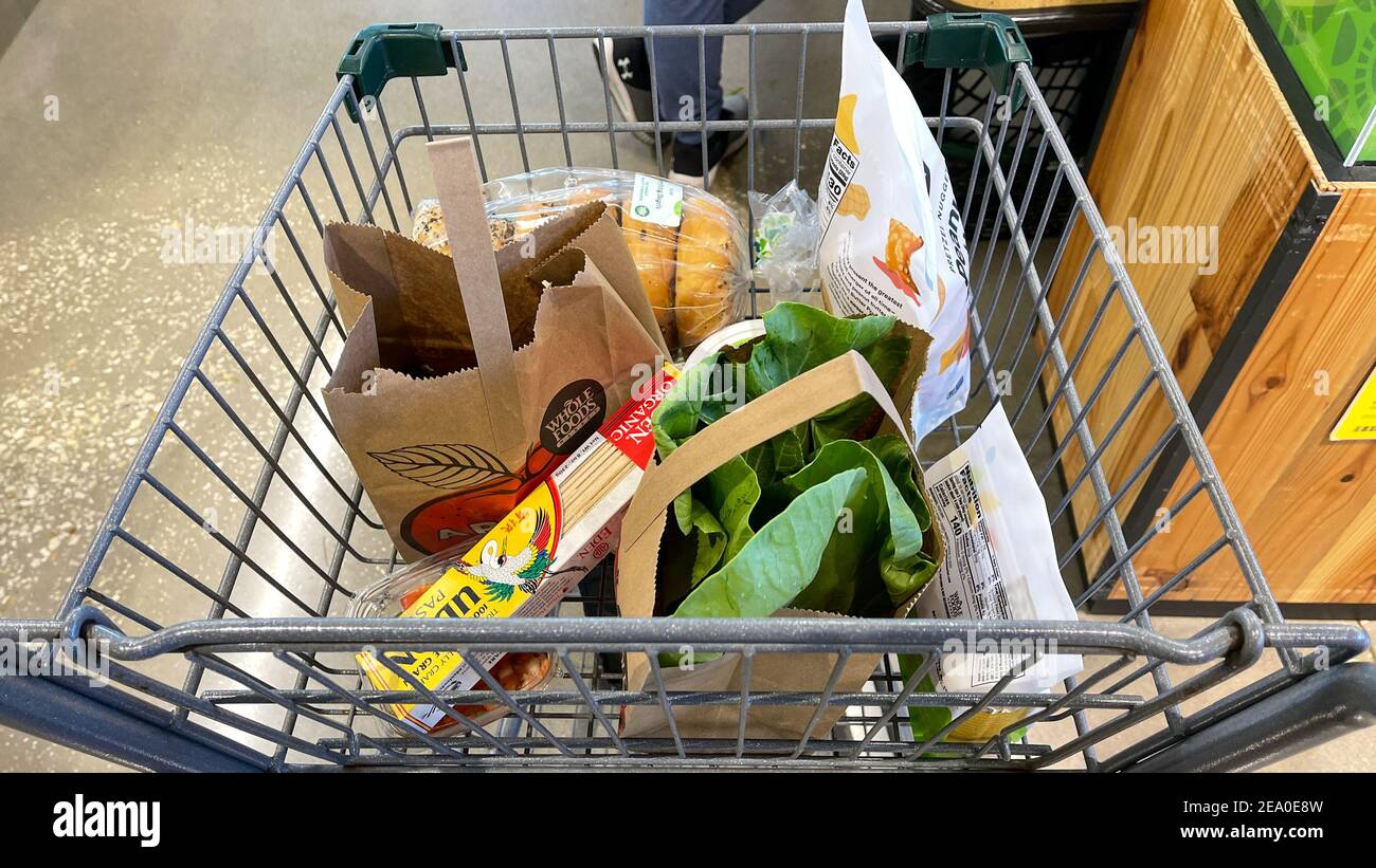 Orlando,FL USA - January 18, 2021:  A grocery cart with groceries at a Whole Foods Market grocery store in Orlando, Florida. Stock Photo