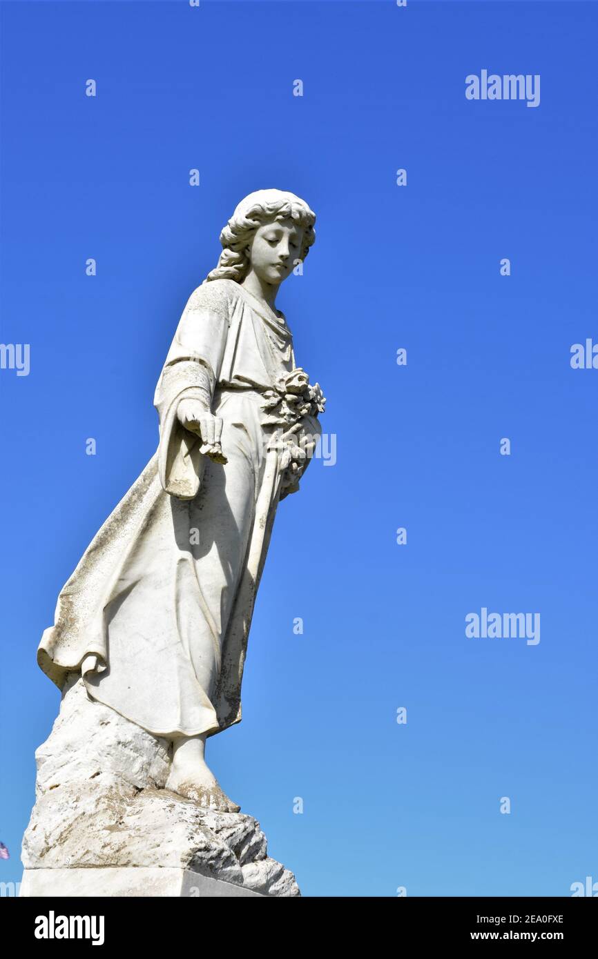 Angel statues in a California Catholic public cemetery with open sky