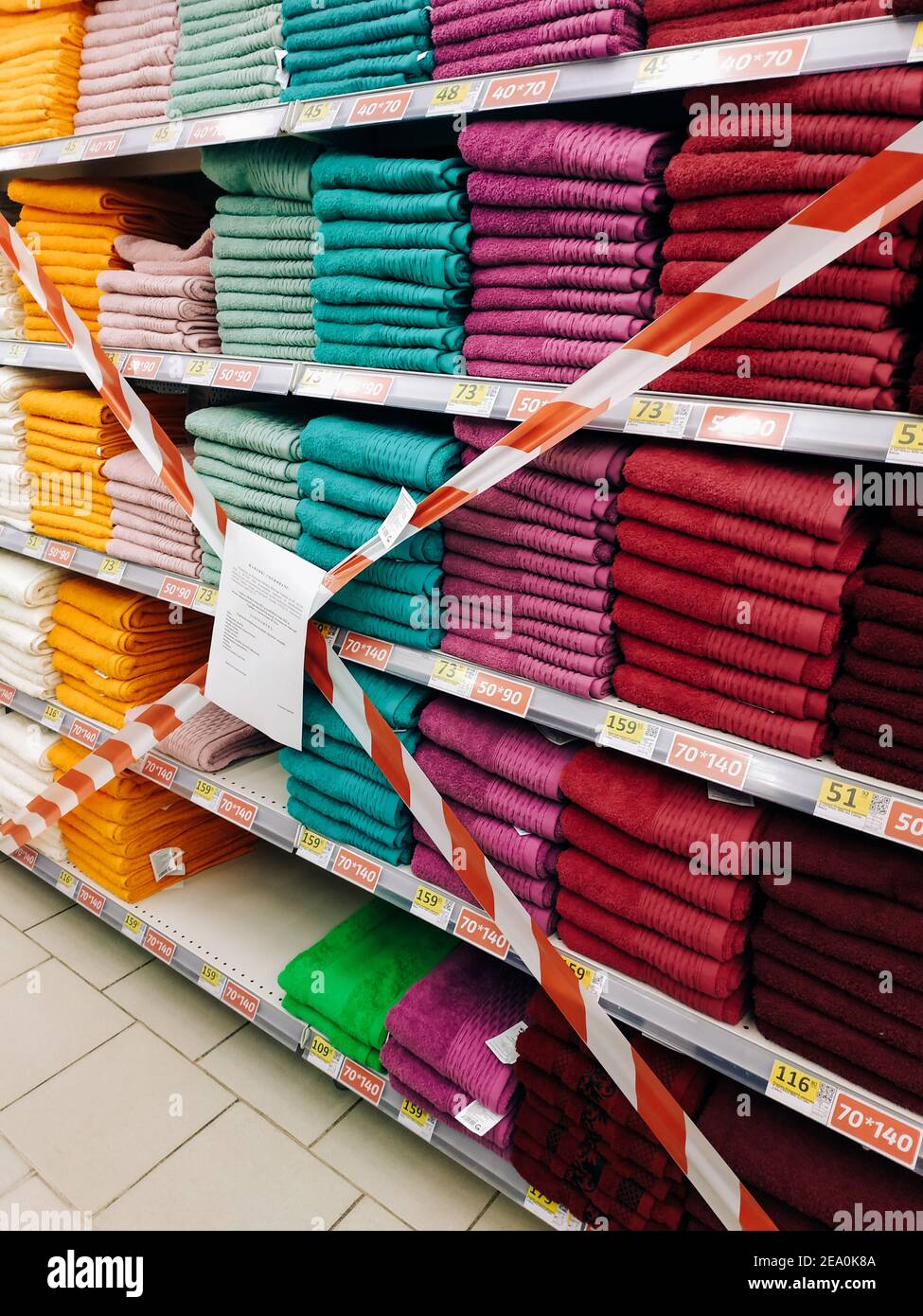 Supermarket shelf taped off, products not for sale during lockdown. Mykolaiv, Ukraine - January 10, 2021 Stock Photo