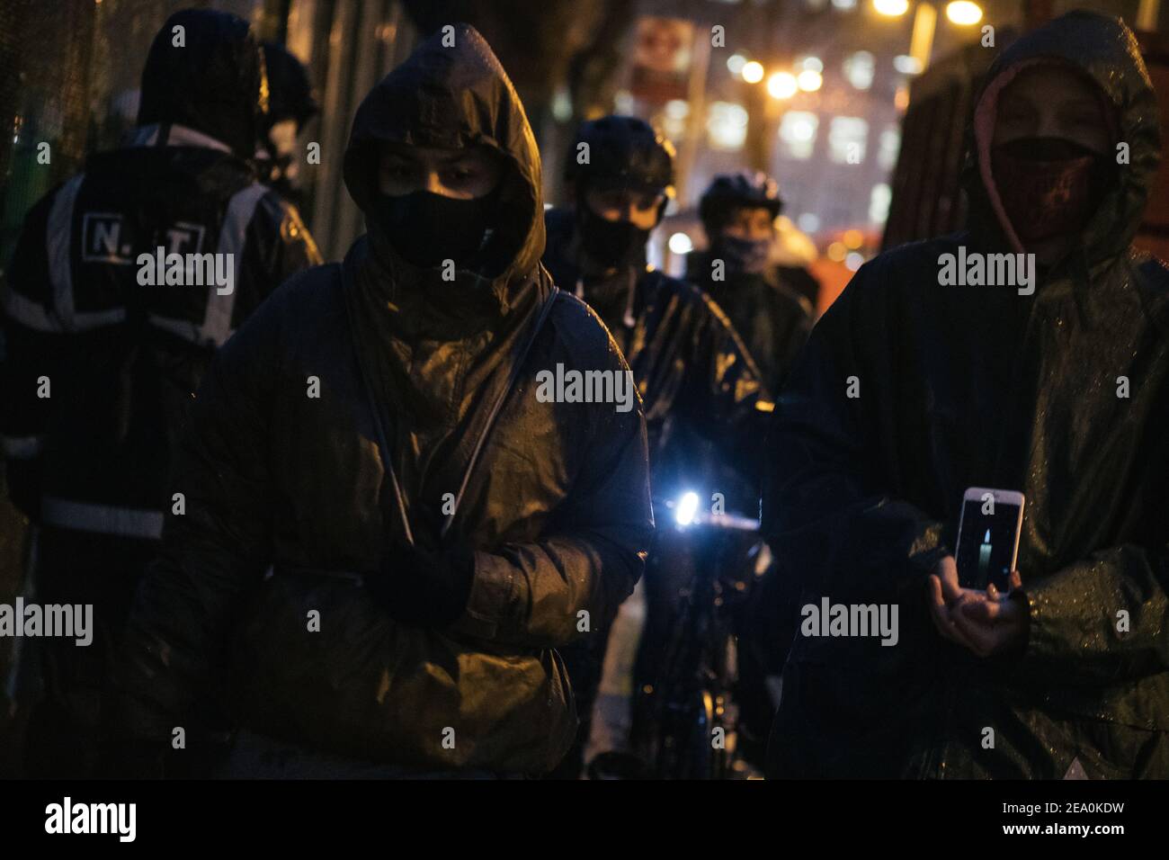 London, UK. 6th February, 2021. Candlelit vigil in remembrence of the lost trees at Euston Square, London as part of the Stop HS2 protest February 6th 2021. Women carry candles as the NET working for HS2 look on Credit: Denise Laura Baker/Alamy Live News Stock Photo